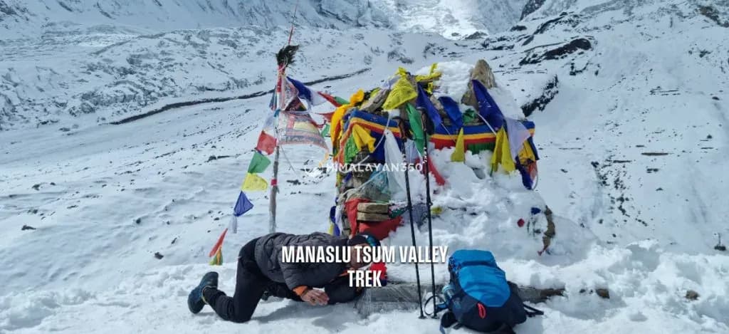 Trekker lying on the ground to click a photo in manaslu trek
