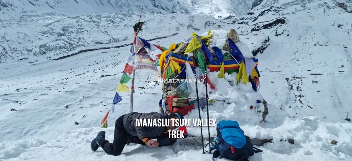 Trekker lying on the ground to click a photo in manaslu trek